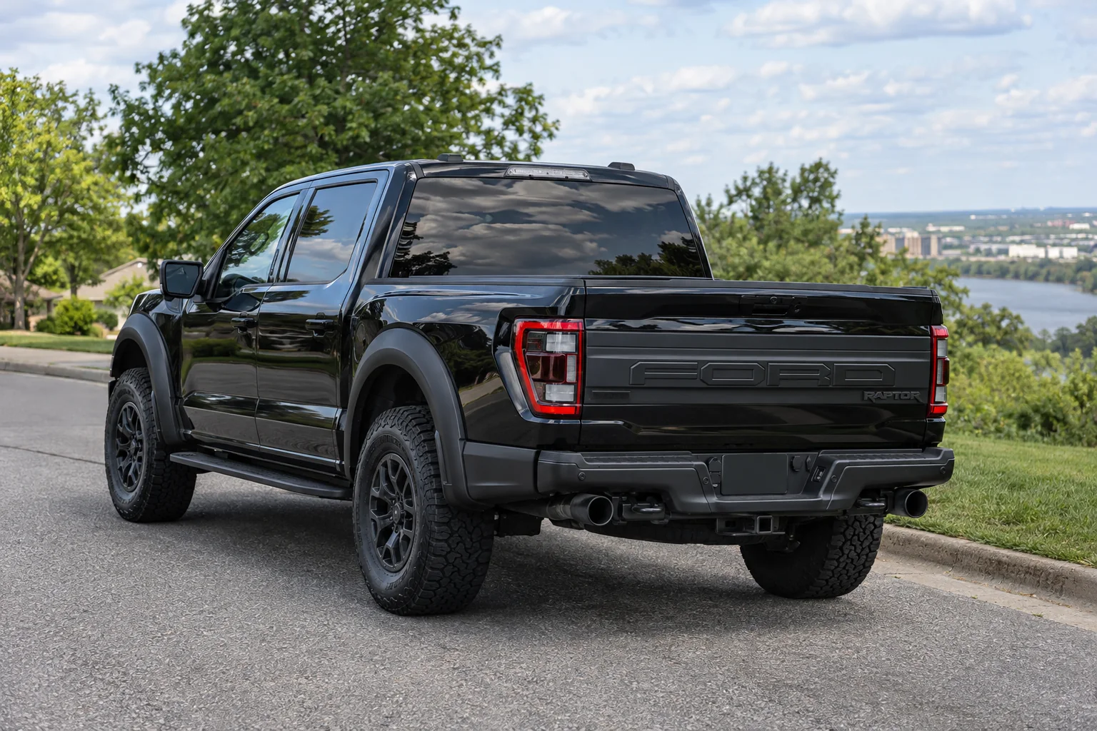 A black Ford F-150 Raptor with tinted rear glass