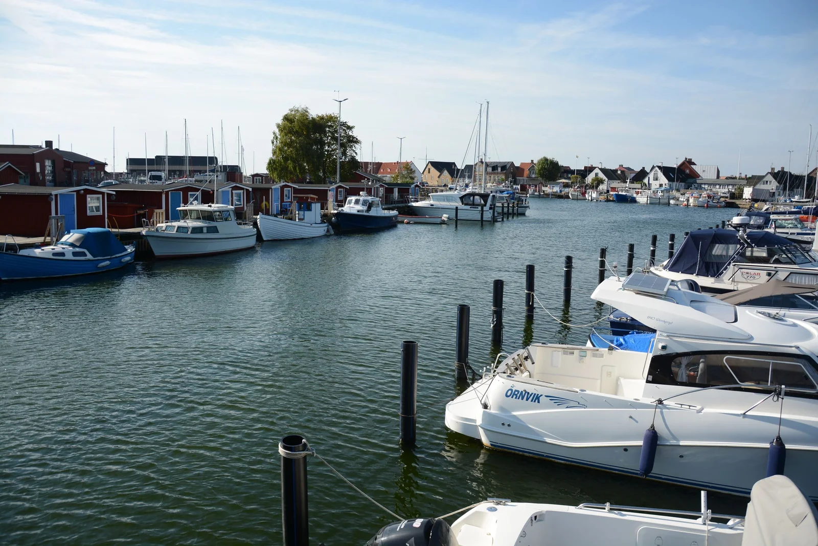 Boats tied up at a marina on a sunny day